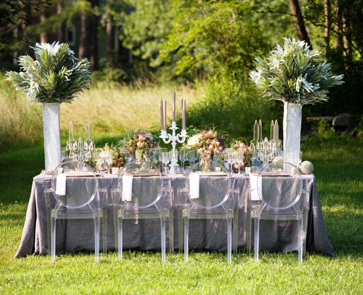 Outdoor wedding table setting with flowers on top.